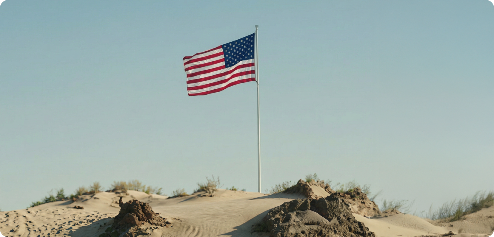 American flag on desert sand dunes — patriotic healthcare mission